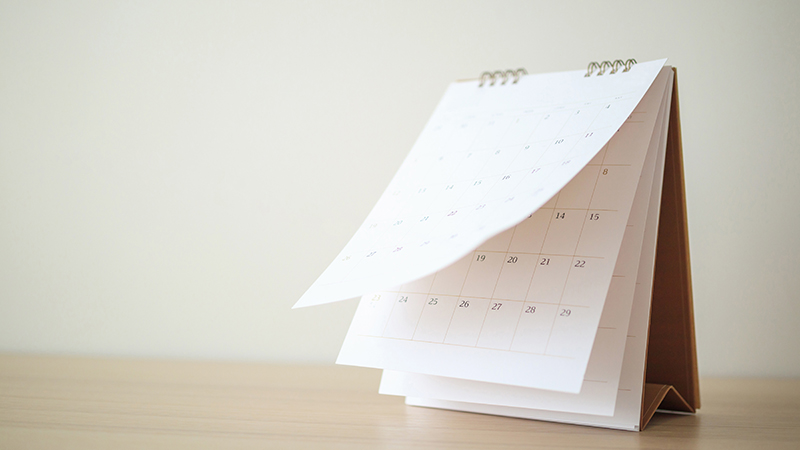 Calendar page flipping sheet on wood table background business s